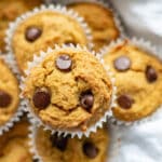 low carb pumpkin muffins with chocolate chips on a tea towel in a bowl