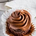 close up angle view of a keto chocolate cupcake with chocolate frosting