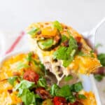 a casserole dish of keto cheeseburger casserole being served.