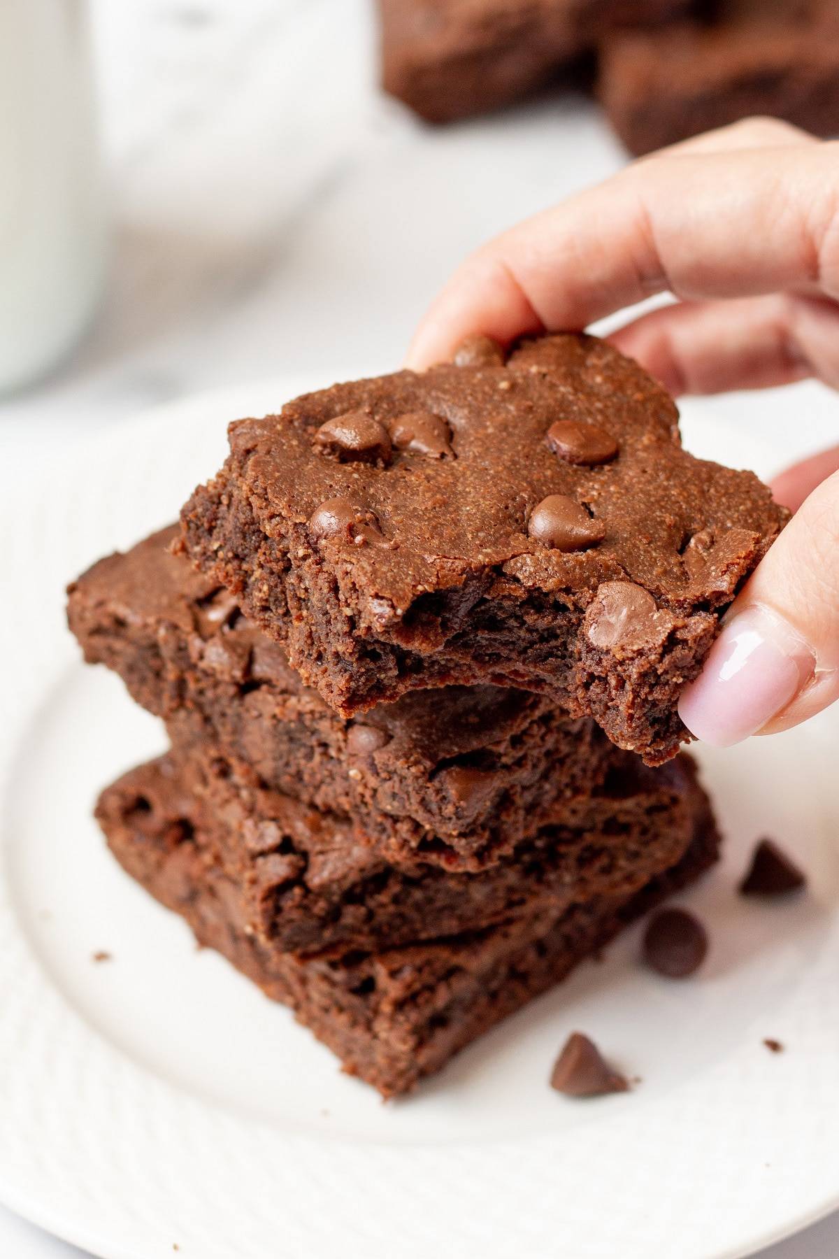 hand holding a keto brownie with a bite out