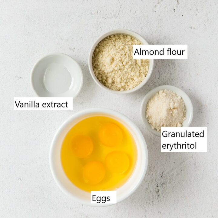 4 small bowls with the ingredients needed for crepes including flour, sweetener, and eggs.