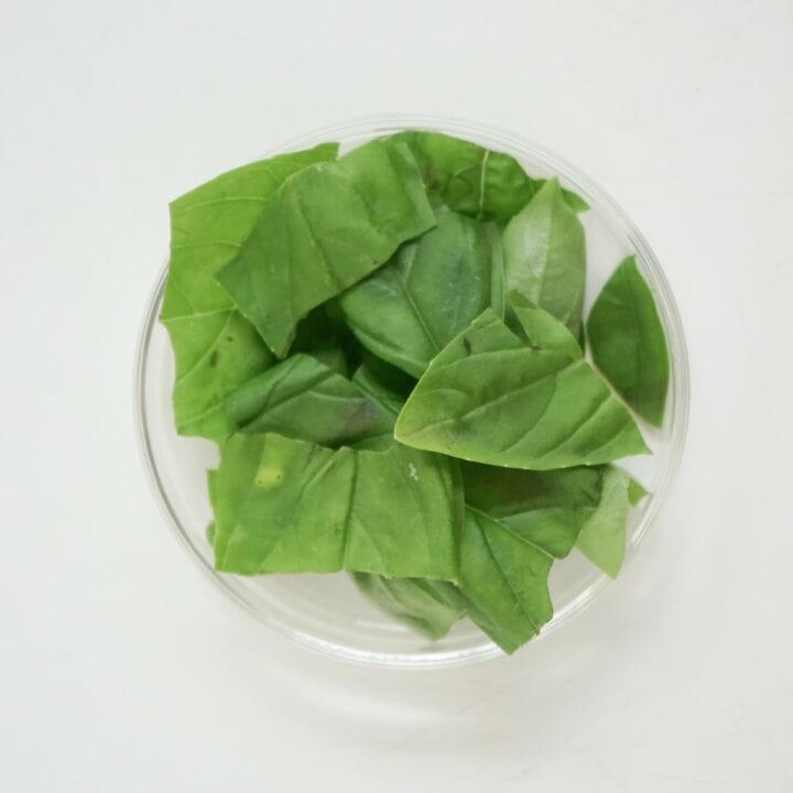 Small bowl of torn basil leaves.