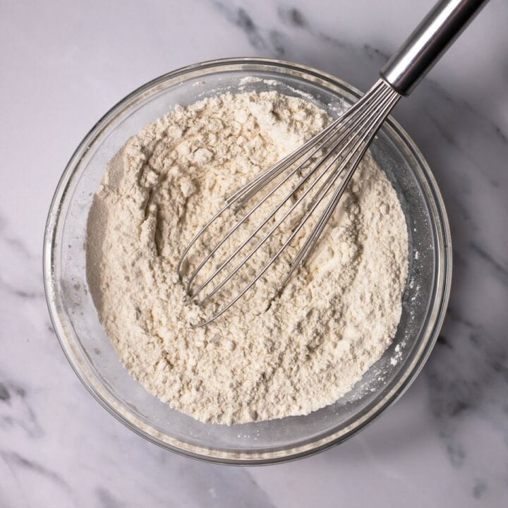 Glass bowl with whisked dry cake ingredients.