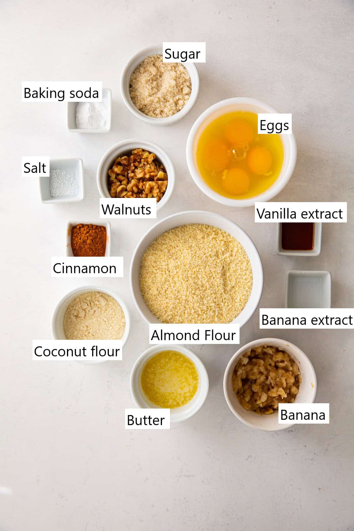 All of the ingredients needed to make Keto banana bread in separate bowls on a counter.