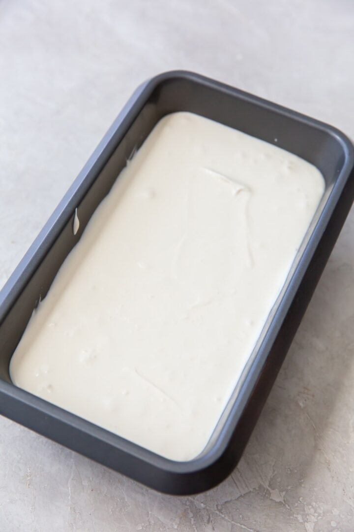 A large loaf pan filled with unfrozen ice cream mixture.