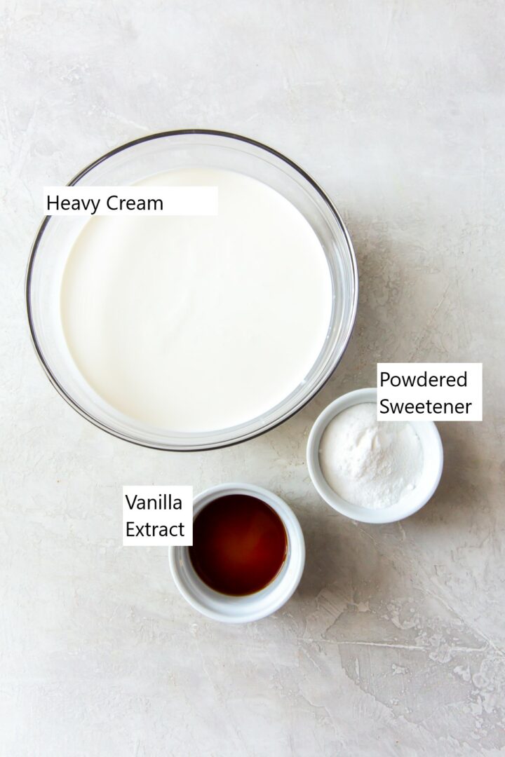 Ingredients for keto ice cream in separate bowls, including cream, sweetener, vanilla.