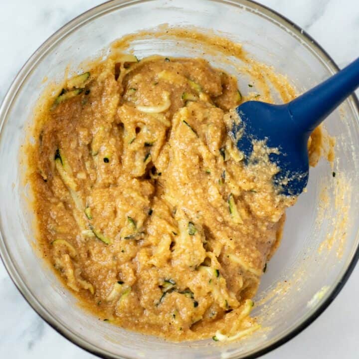 Keto zucchini bread batter fully mixed in a glass bowl.
