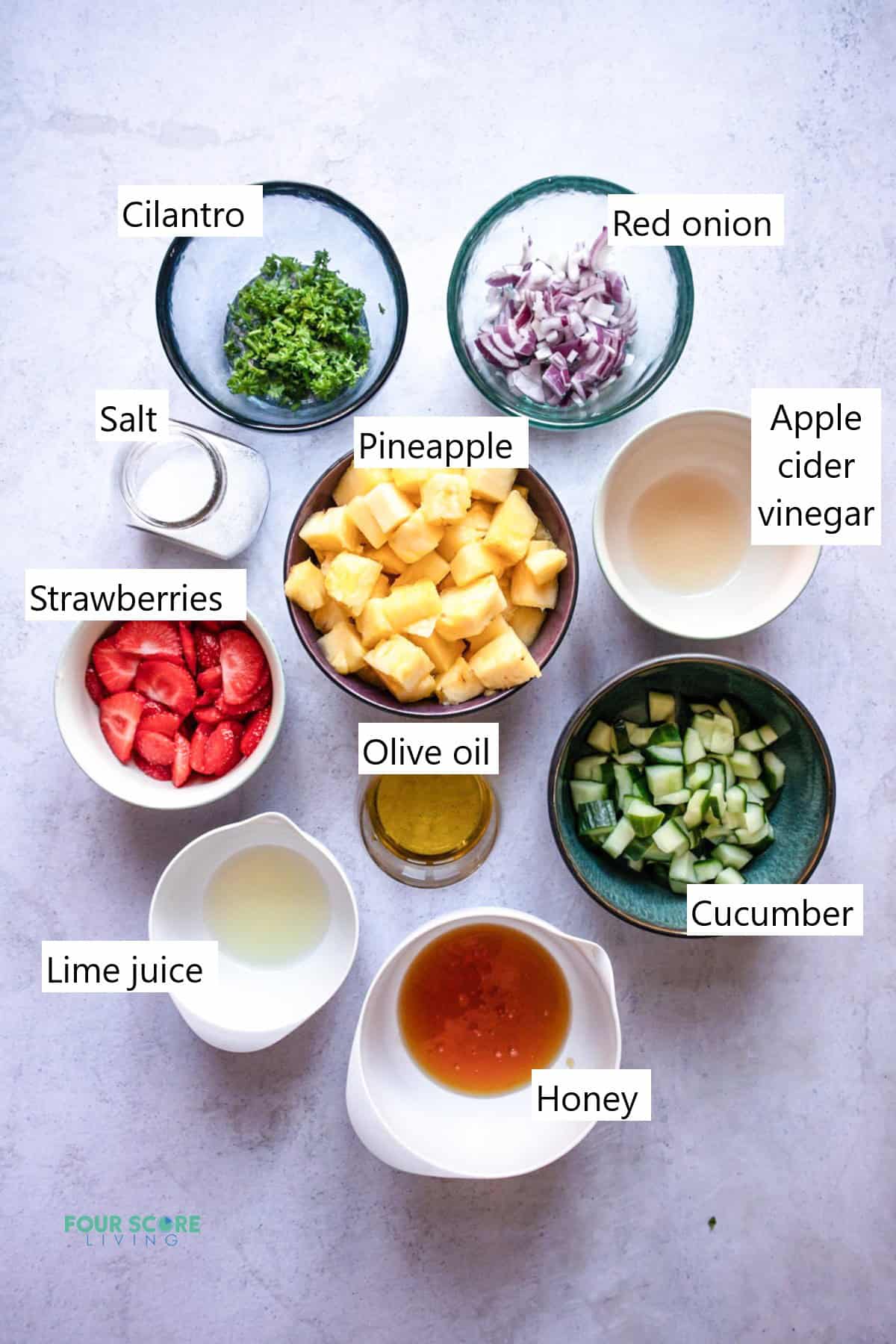 Ingredients needed to make pineapple salad in separate bowls.