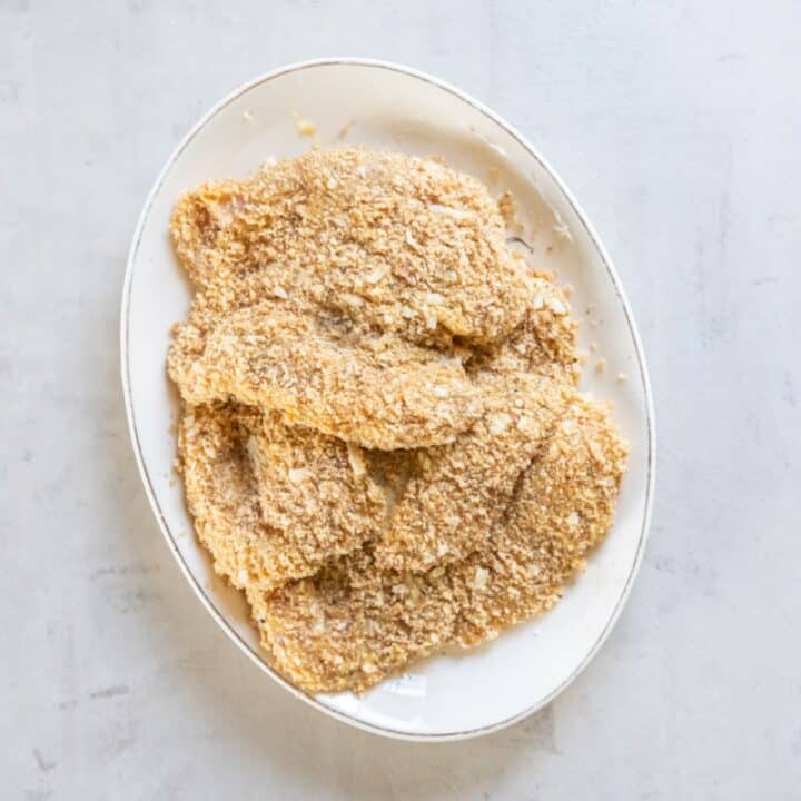 Breaded chicken cutlets ready to be fried.