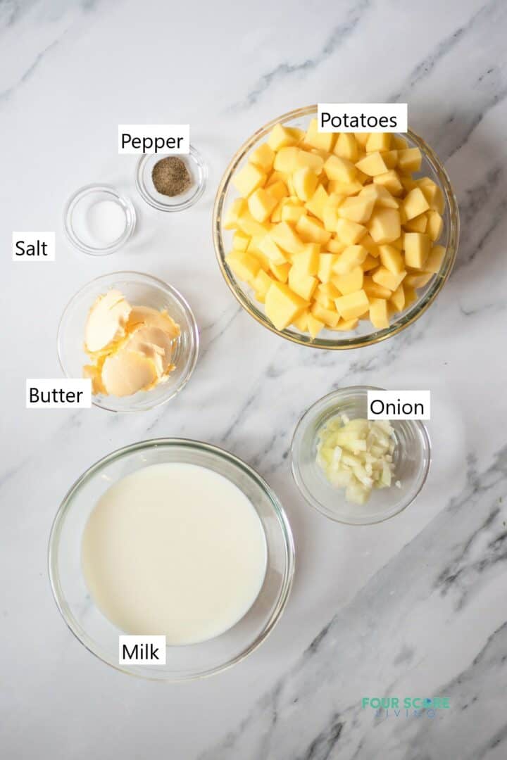 Ingredients for potato soup in individual bowls.