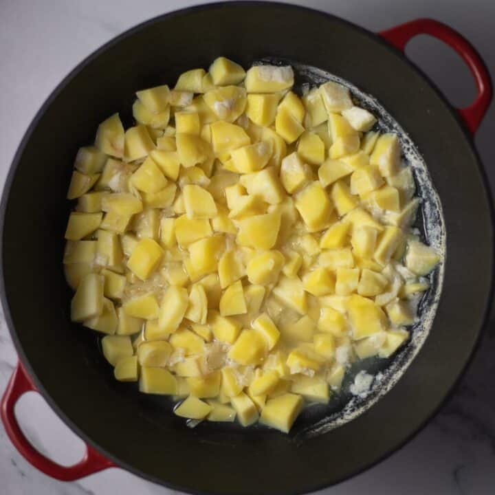 Stock pot with cooked potatoes.