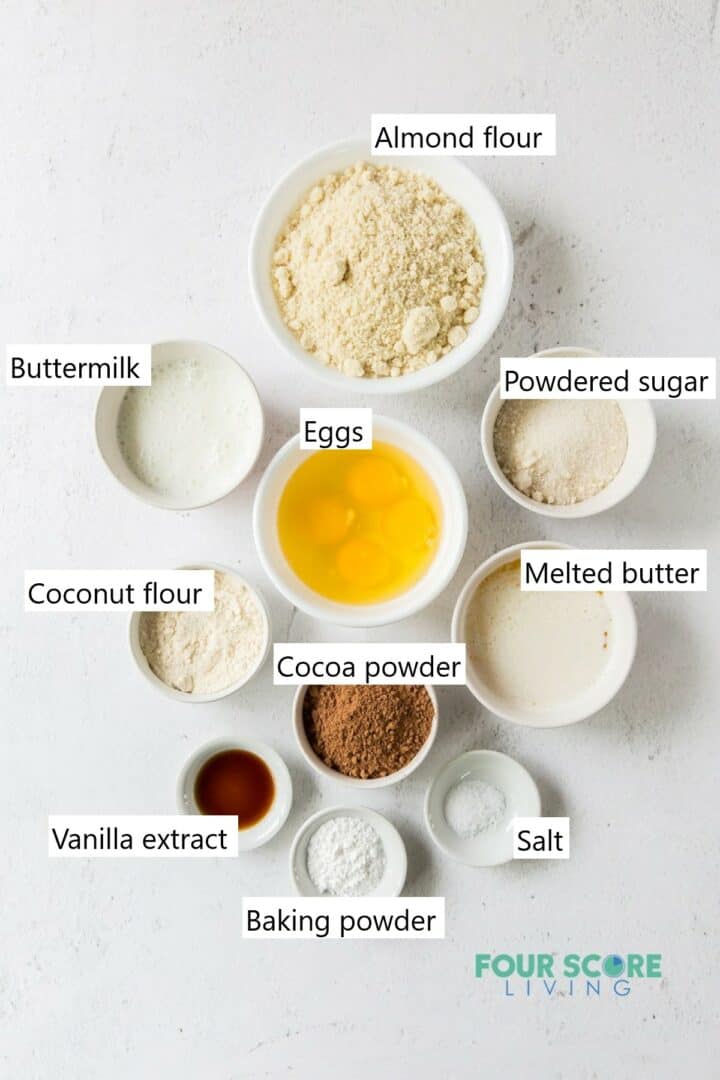 The ingredients needed to make an almond flour chocolate cake in individual bowls.