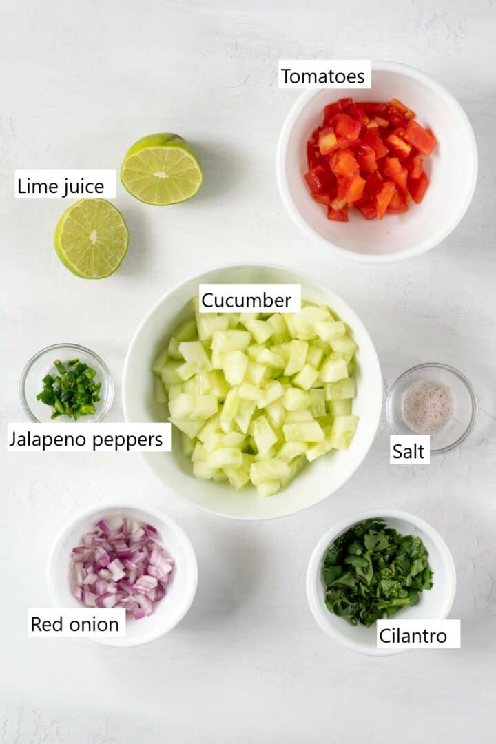 Ingredients to make Cucumber Salsa, chopped and in separate bowls.