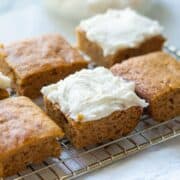 keto pumpkin bars on a wire rack with frosting.