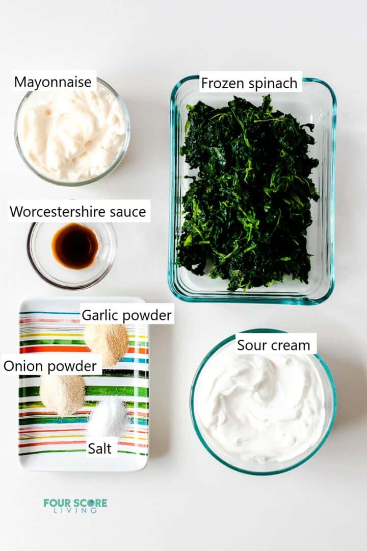 Ingredients for making keto spinach dip in individual bowls and plates.