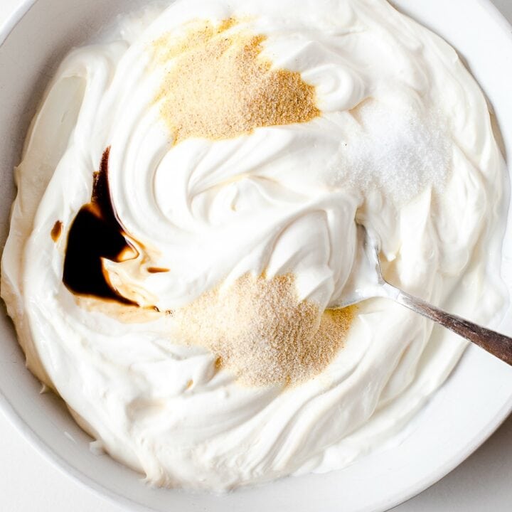 Spices and Worcestershire sauce being mixed into the mayo and sour cream mixture.