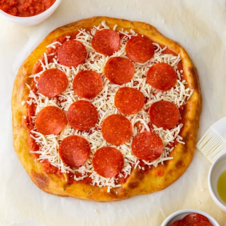 A fully assembled pepperoni pizza ready to be baked.