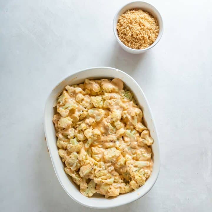 Baking dish containing the mixed cauliflower and sauce.