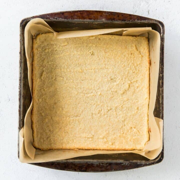 Baked lemon bars crust in a square cake pan.