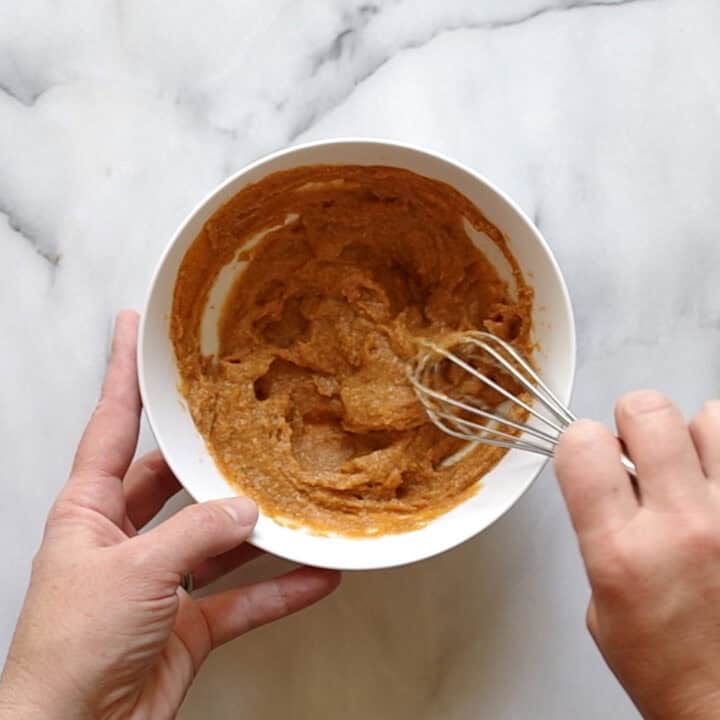 All the ingredients being whisked together in a bowl.