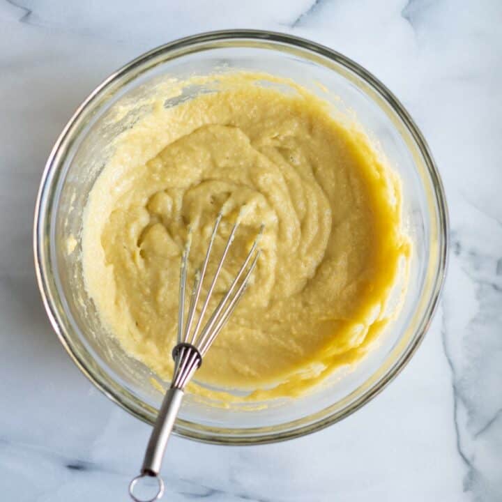 Glass mixing bowl with whisked low carb stuffing bread batter.