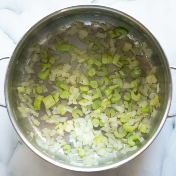 Pot with cooked onions and celery.