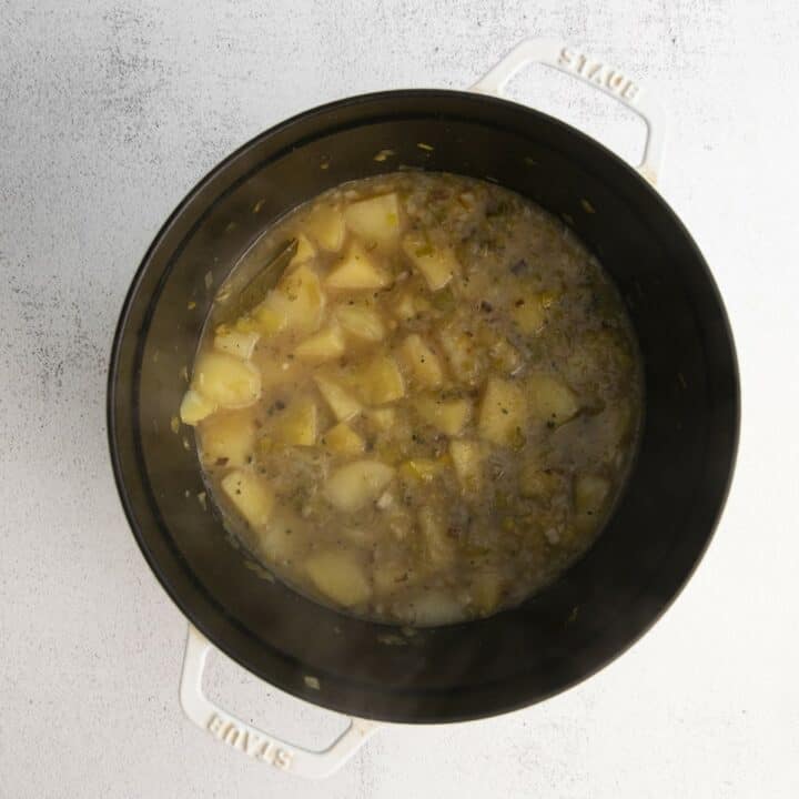 A Dutch oven with all of the fully cooked ingredients for making a magic leek soup ready to be blended.