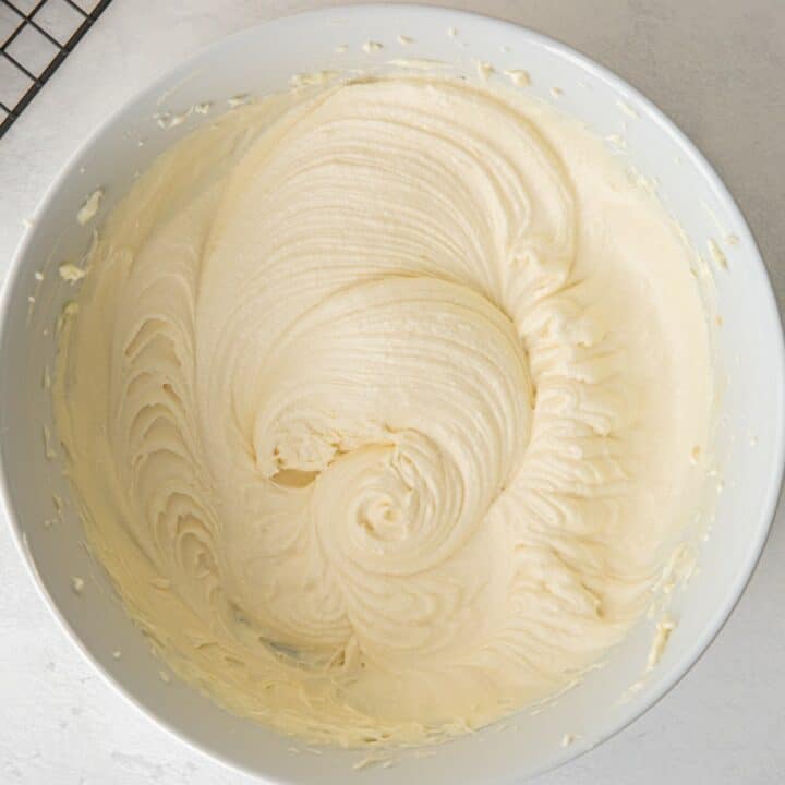 Bowl containing fully mixed keto cream cheese frosting. Ready for frosting the carrot cake.