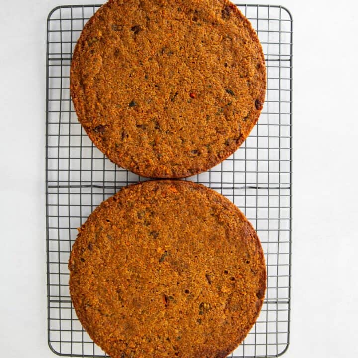 Two fully baked keto carrot cakes removed from the cake pans and placed on a wire rack to cool.