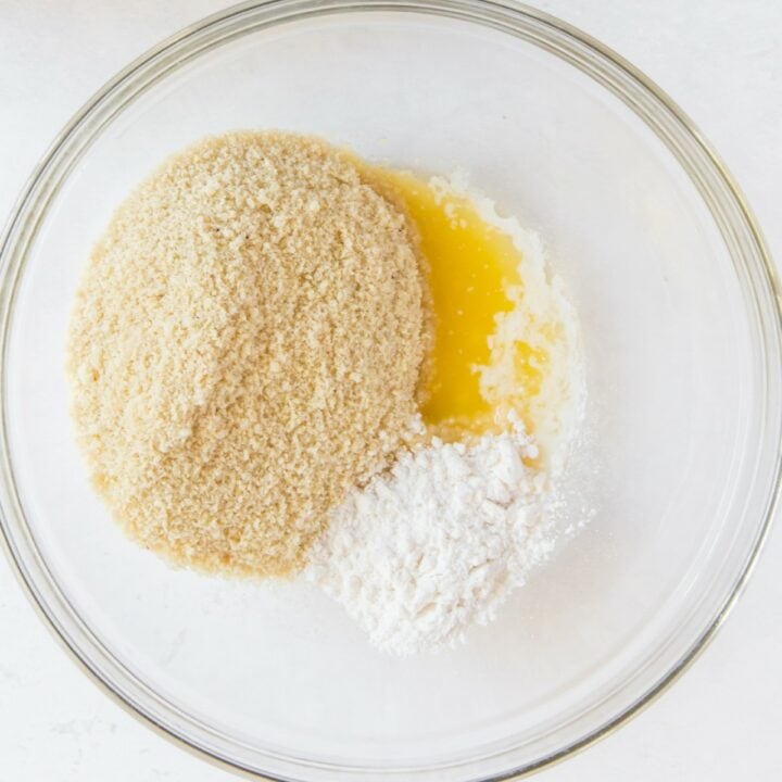 Almond flour, powdered sweetener and melted butter in a glass bowl.