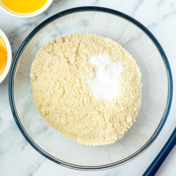 Glass bowl with the dry ingredients of almond flour, salt and baking soda.