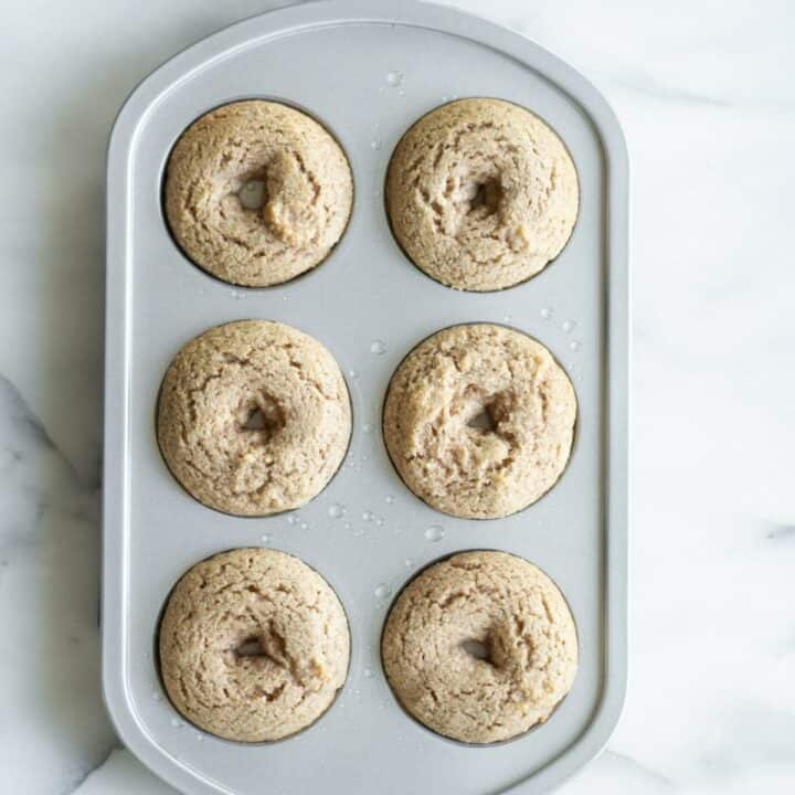 A donut pan with six fully baked keto donuts.