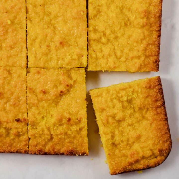 Fully baked keto cornbread cut into squares ready to be served.