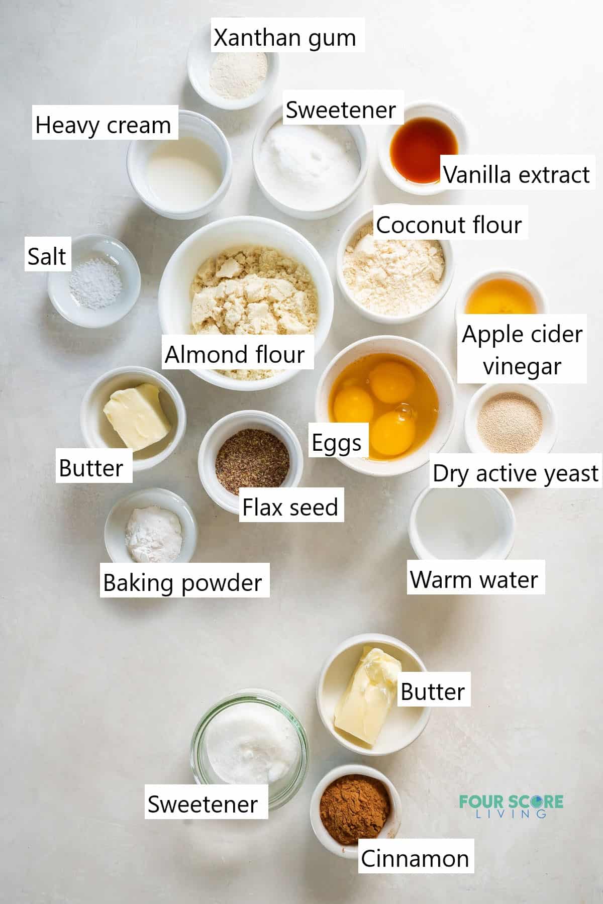 The ingredients needed to make keto cinnamon rolls, all measured into small individual bowls.