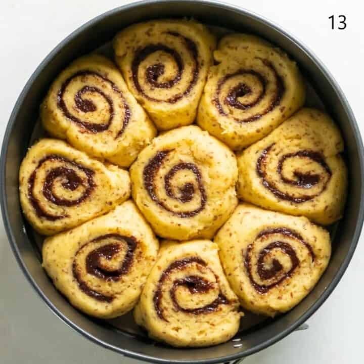 Nine fully risen cinnamon rolls in a cake pan, ready to be baked.