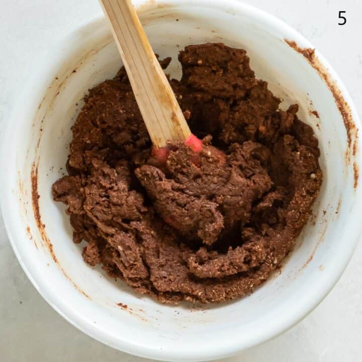 The cinnamon filling ingredients being mixed together with a spatula in a bowl.