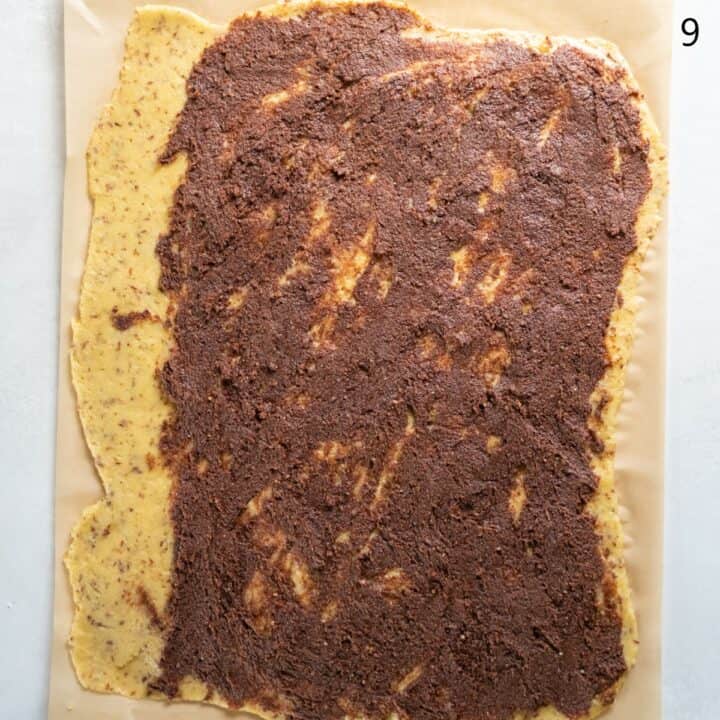 The cinnamon sugar filling mixture spread over the dough, except for the left long edge.