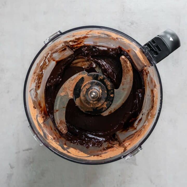 Food processor with blended avocado chocolate pudding.