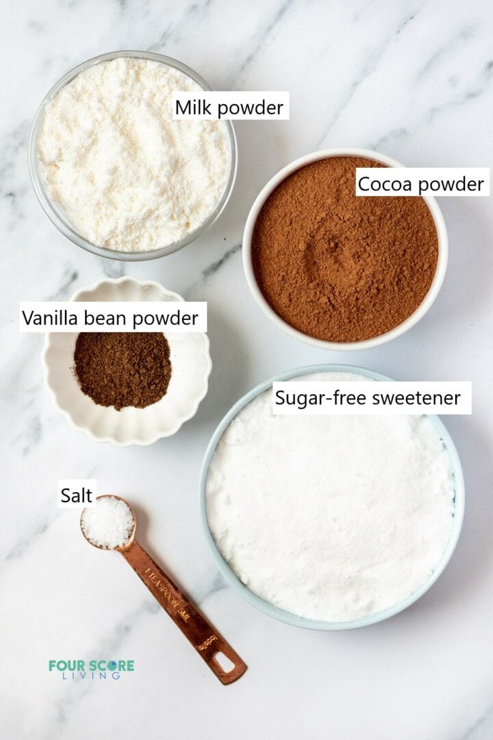 Ingredients needed to make keto hot chocolate mix, all measured and in individual bowls.